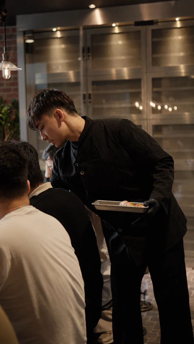Joel attending to guests at the table.
